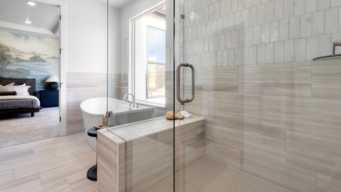 Primary bathroom glass shower and tub.