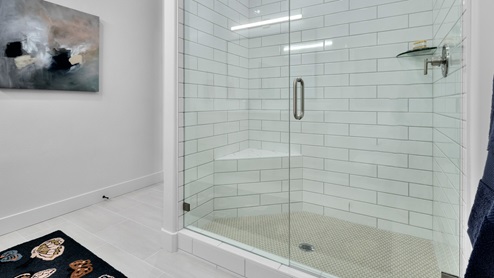 Bathroom with vanity and glass shower.