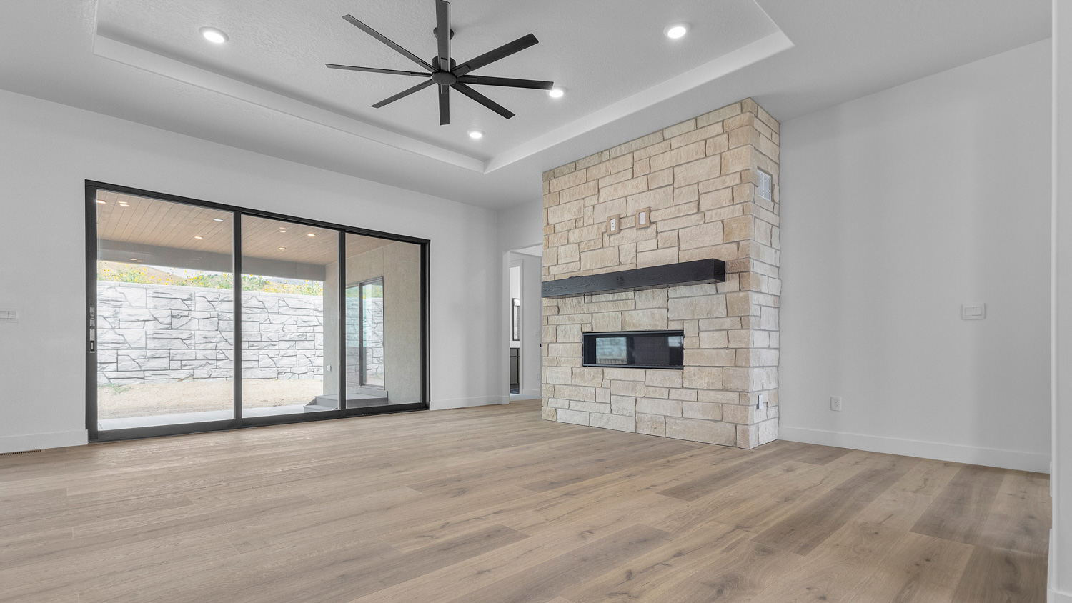 Family room with sliding glass doors and fireplace.