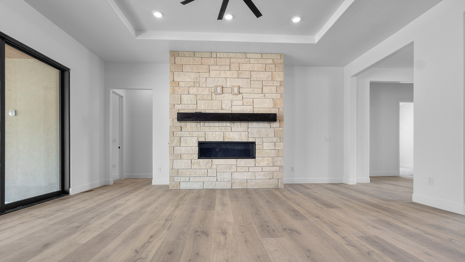 Family room with fireplace and tray ceiling.