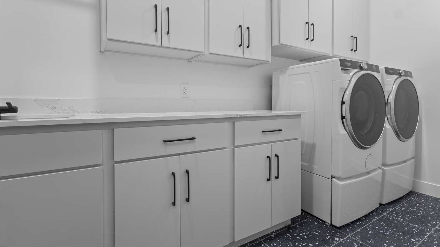 Laundry room with plenty of cabinets.