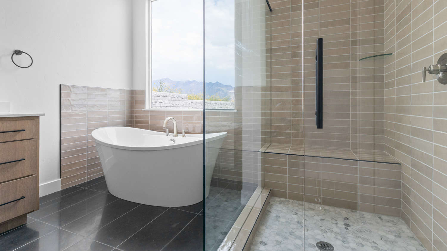 Primary bathroom with soaking tub and glass shower.