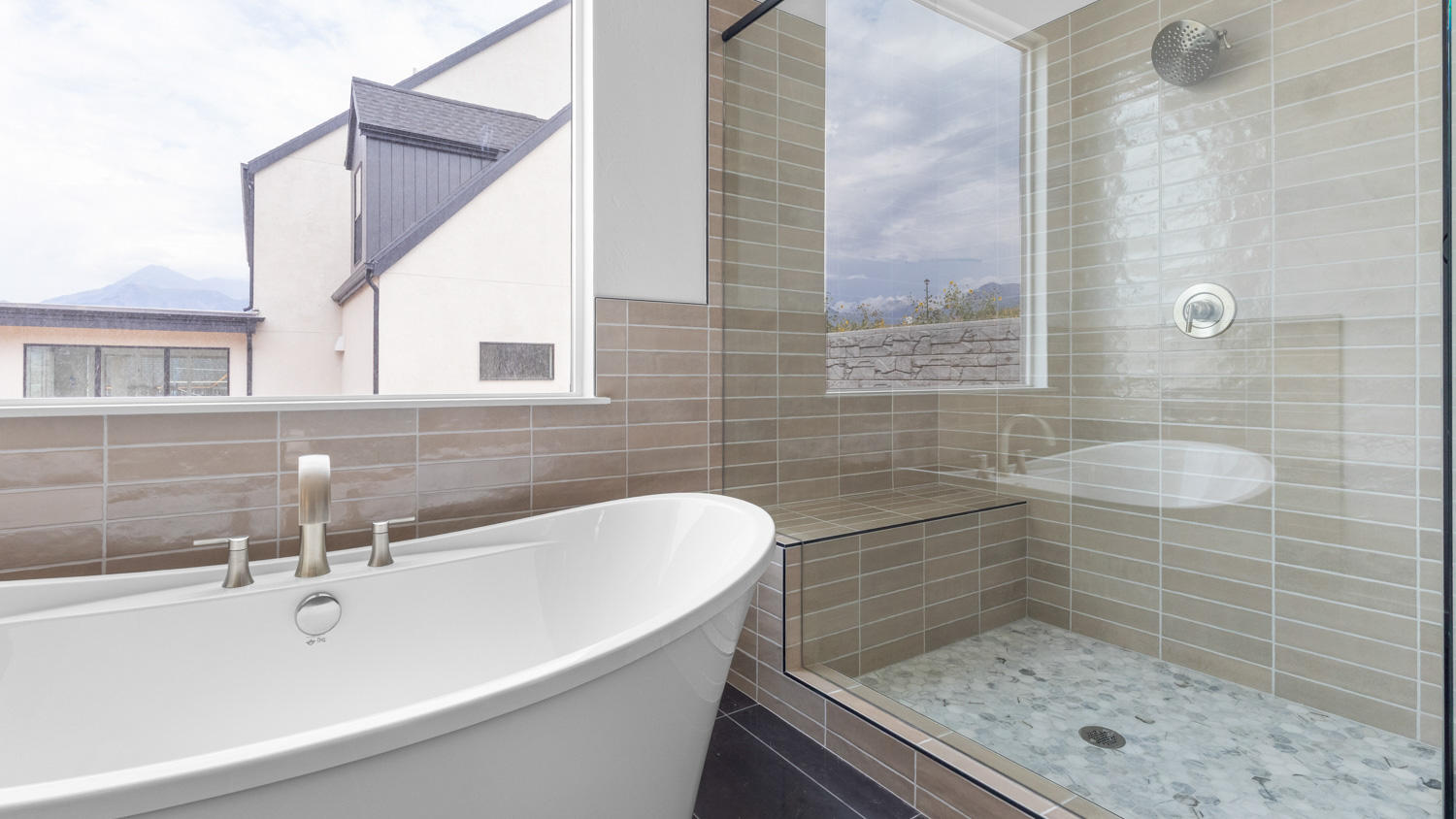 Primary bathroom with soaking tub and glass shower.