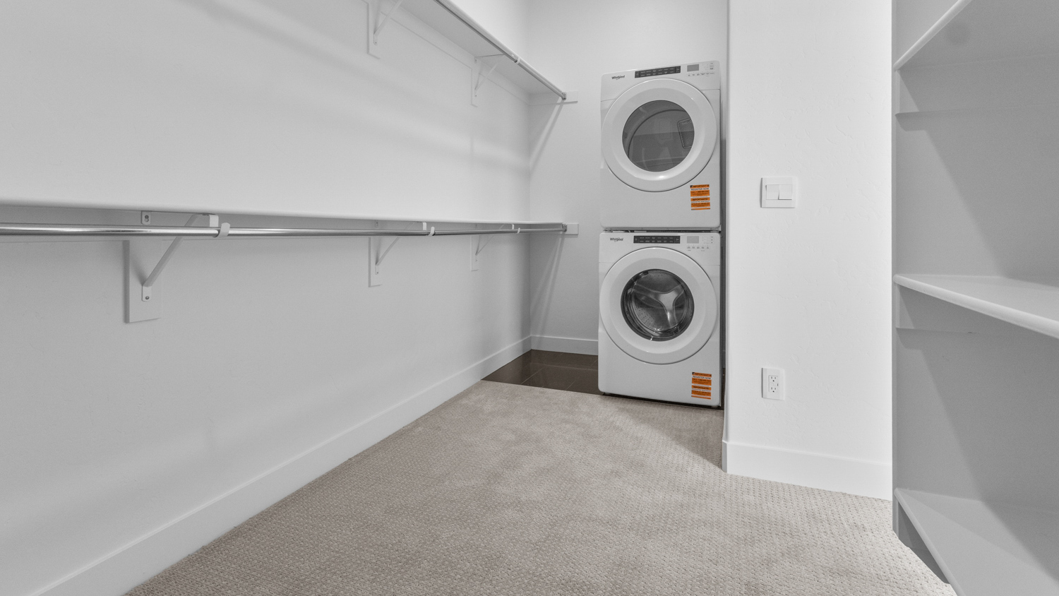 Large walk-in closet with laundry unit.