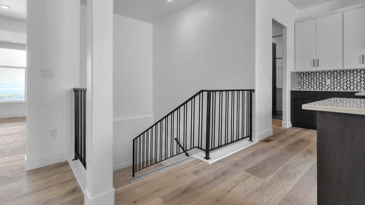 Stair railing off kitchen to basement.