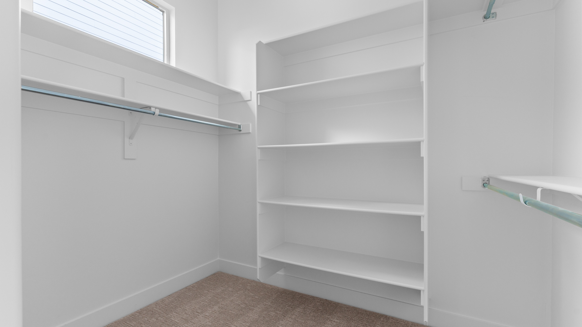 Primary large walk-in closet with window.