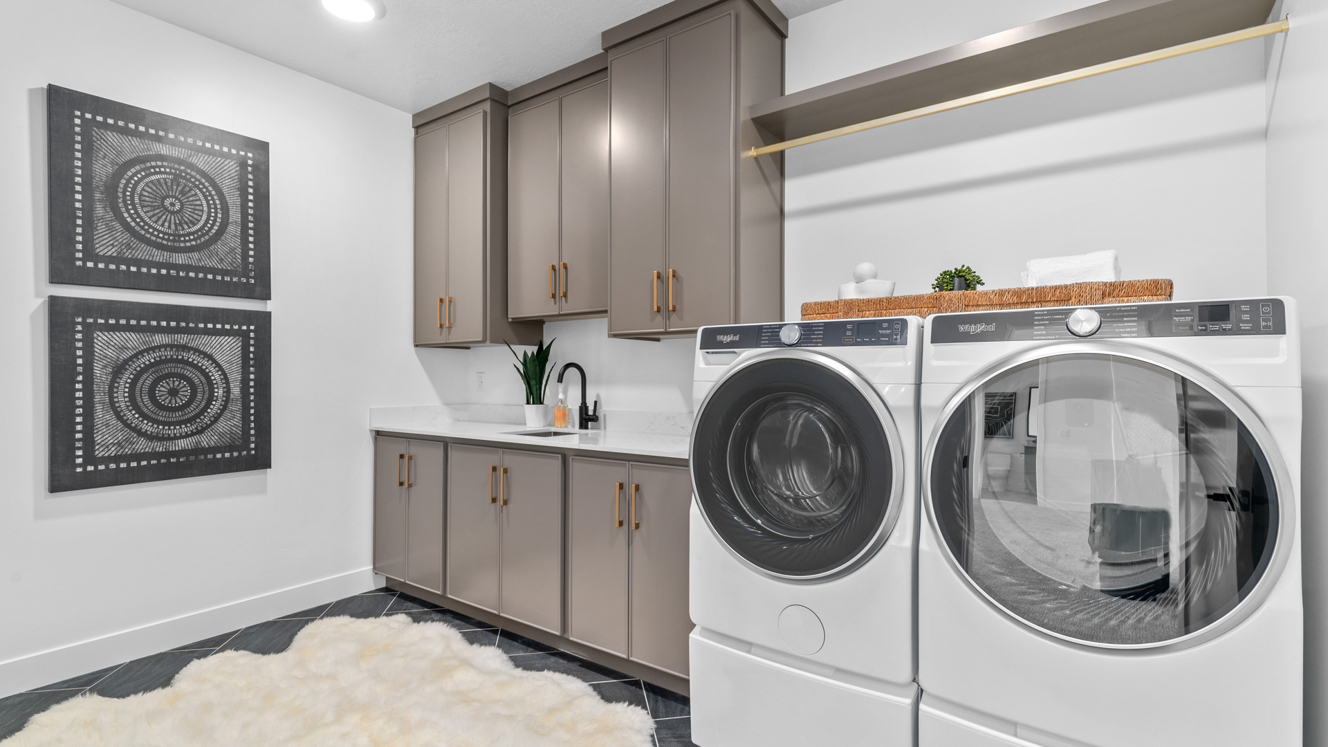 Laundry room with shelving and cabinets.