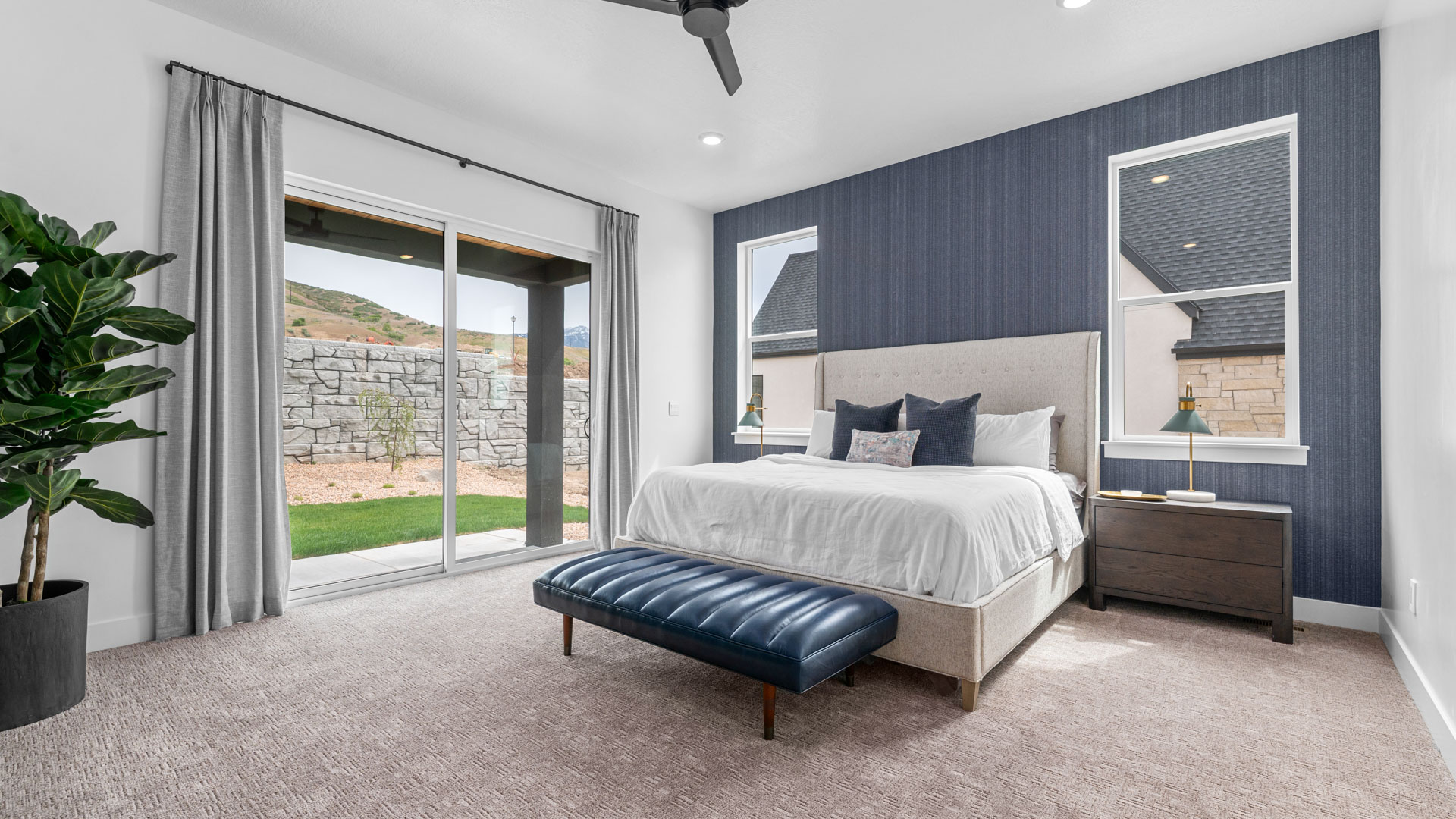 Primary bedroom with windows and large patio doors.