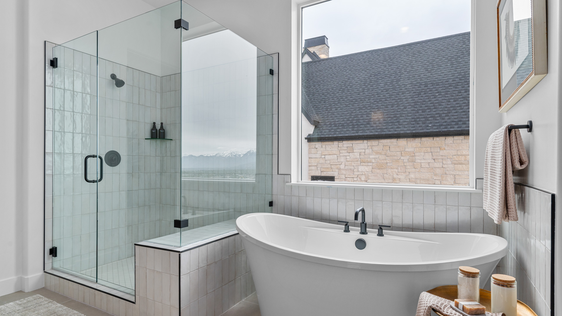 Spacious bathroom with glass shower and tub.