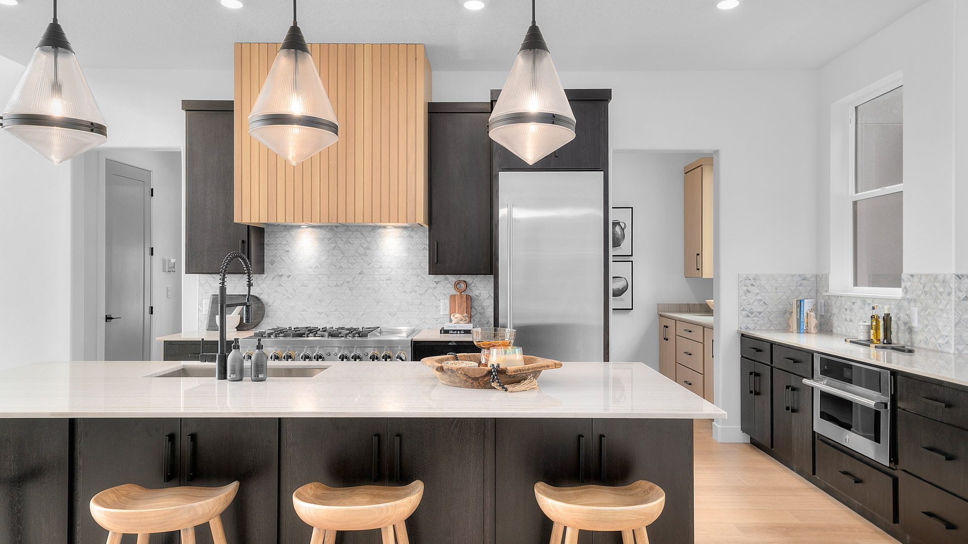 Kitchen space with large kitchen island and dark cabinets.