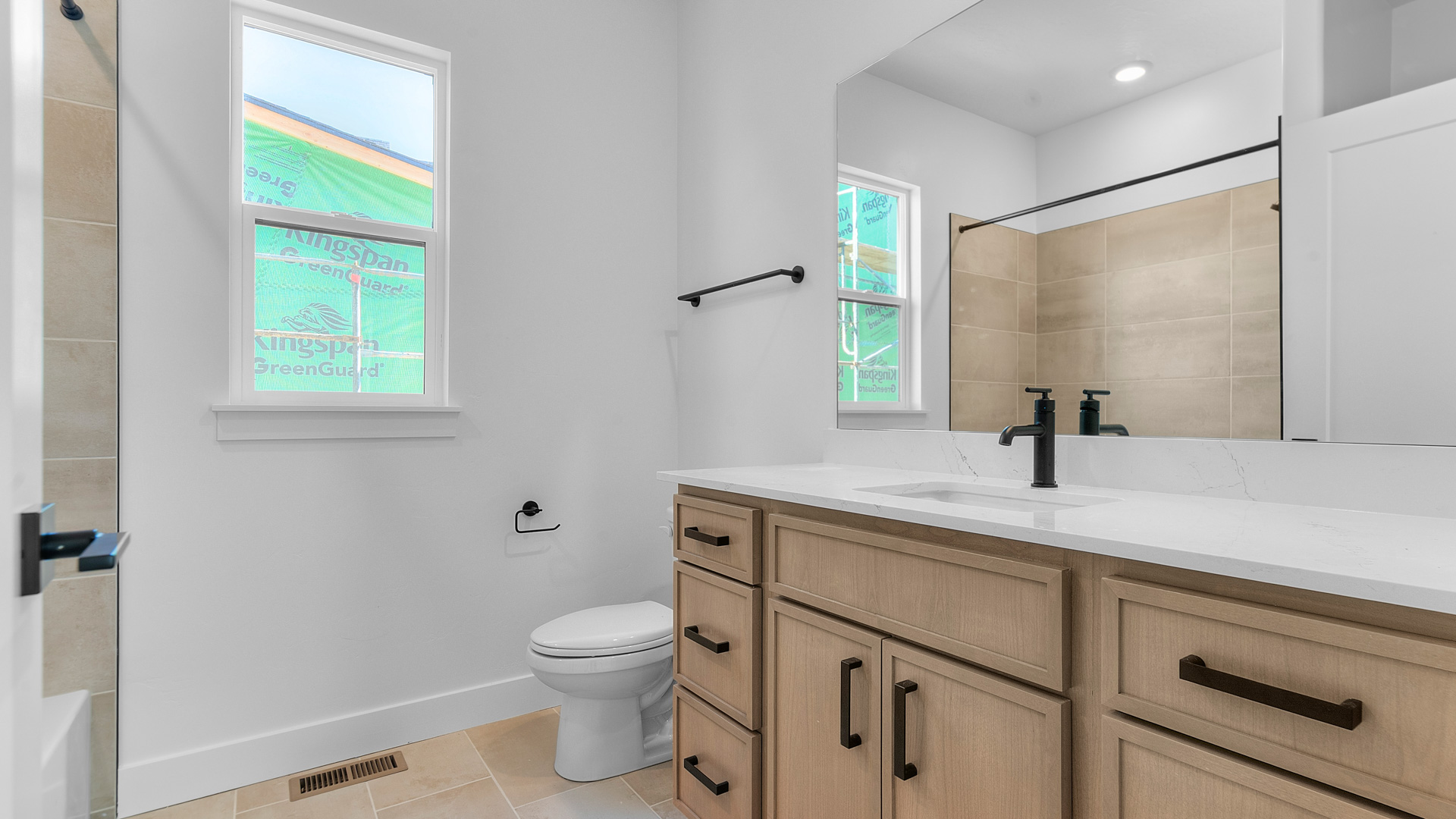 Bathroom with window and quartz countertops.