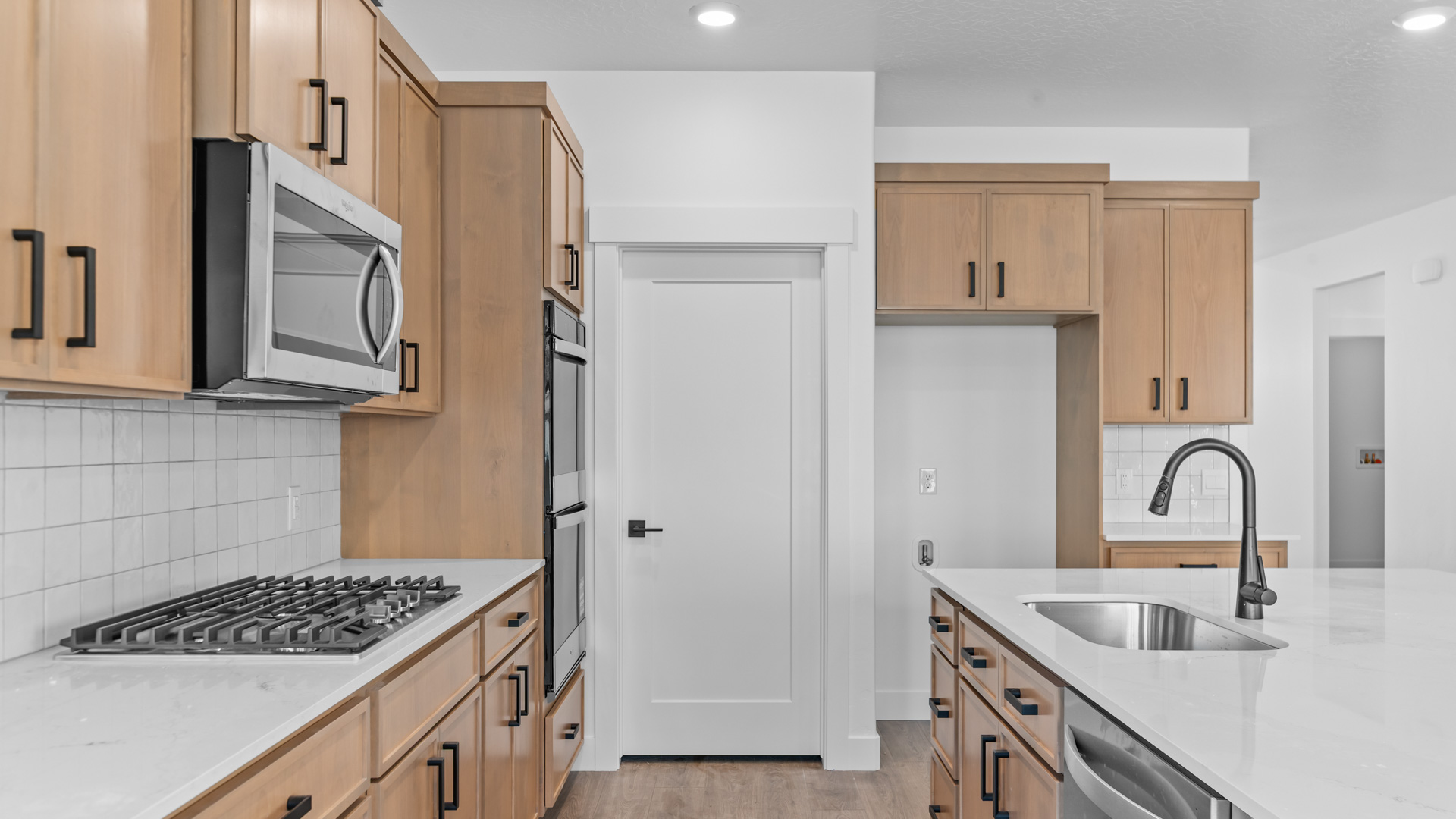 Kitchen with kitchen island, quartz countertops, and stainless steel appliances.
