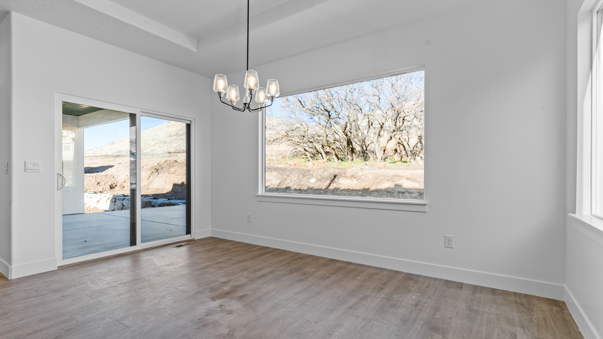 Dining room with large window and patio doors.