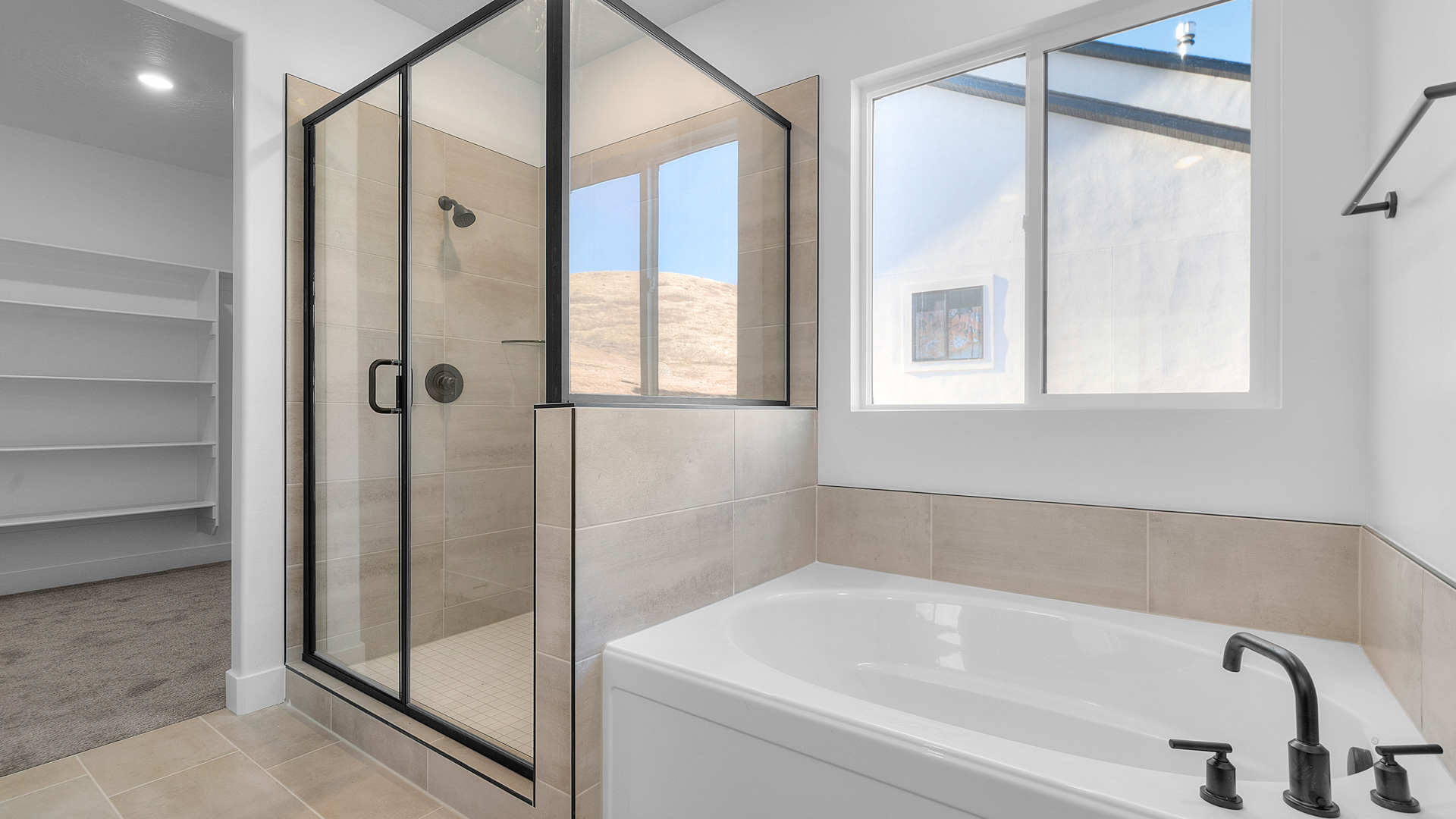 Primary bathroom with glass shower and soaking tub