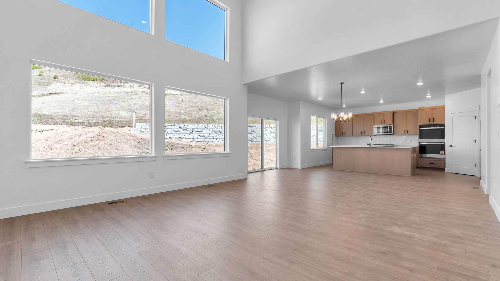 Main living space with two story windows.