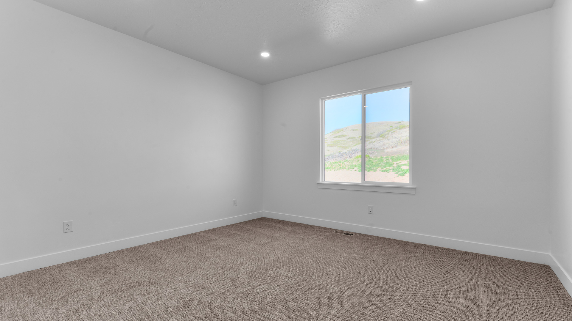Primary bedroom with large window.