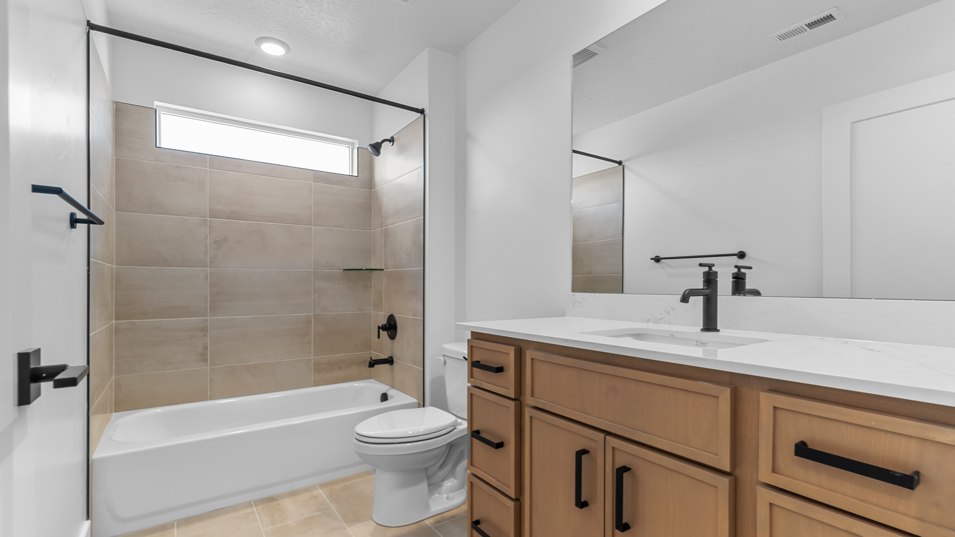 Bathroom with vanity and tub with window.
