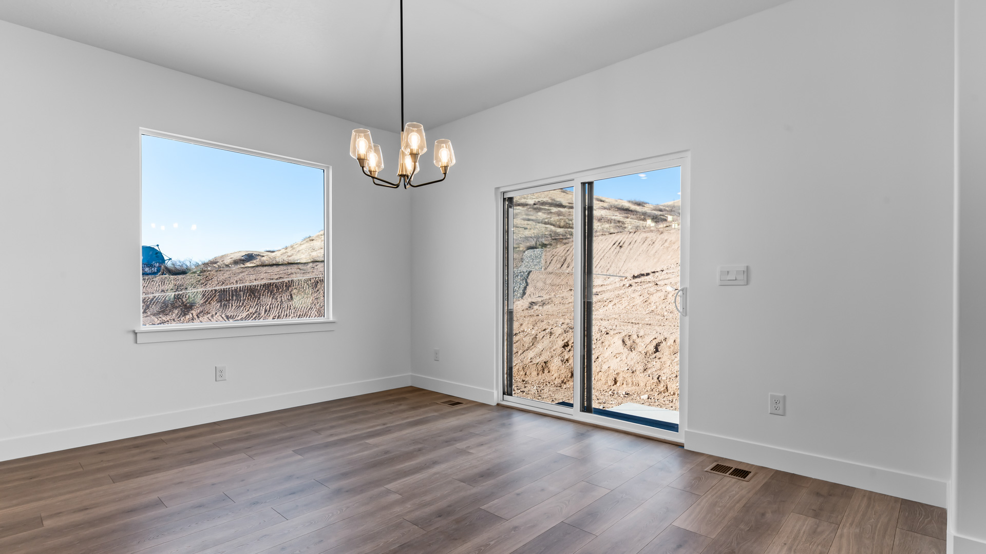 Dining area with large window and patio doors.
