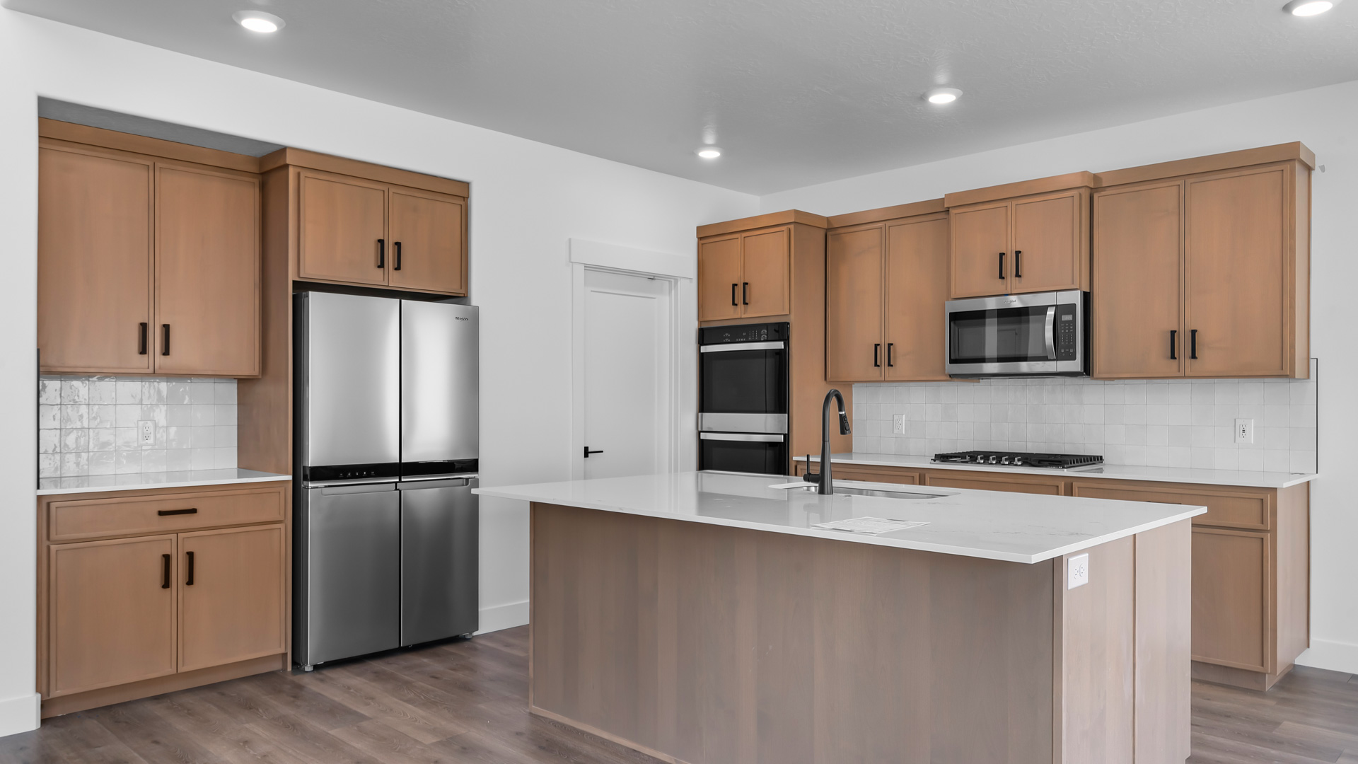 Large kitchen with cabinets and kitchen island.