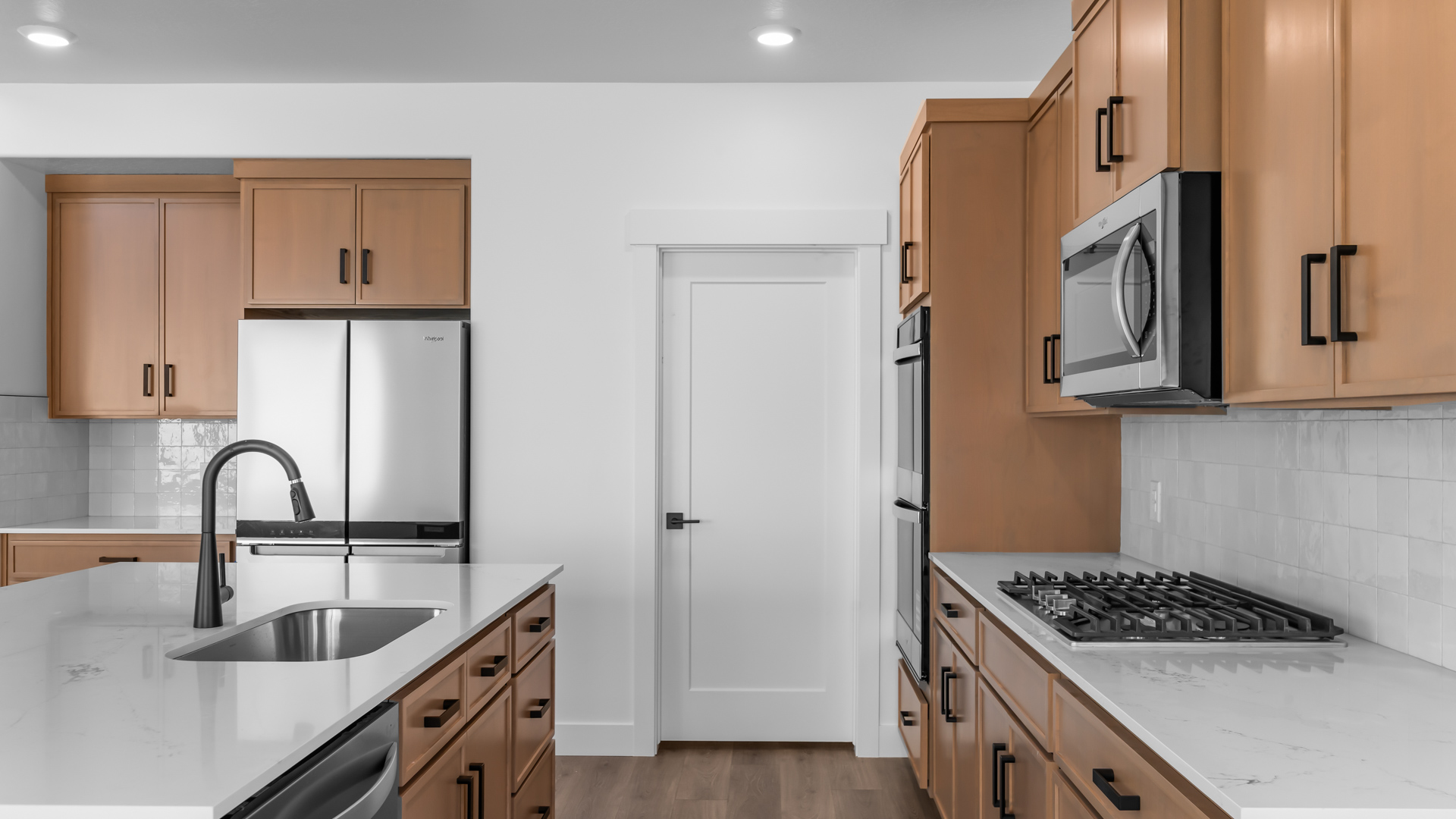 Kitchen island and stainless steel appliances.