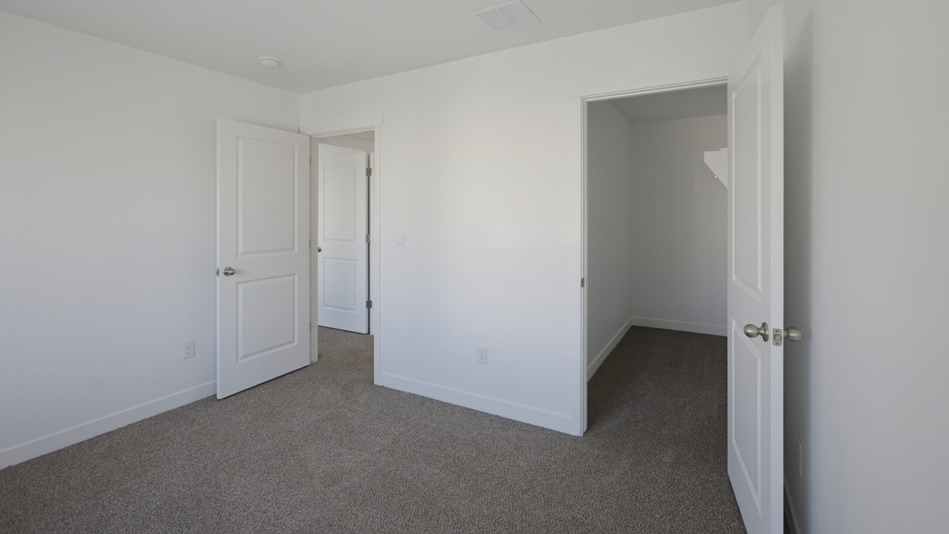Laundry area behind double doors in hallway