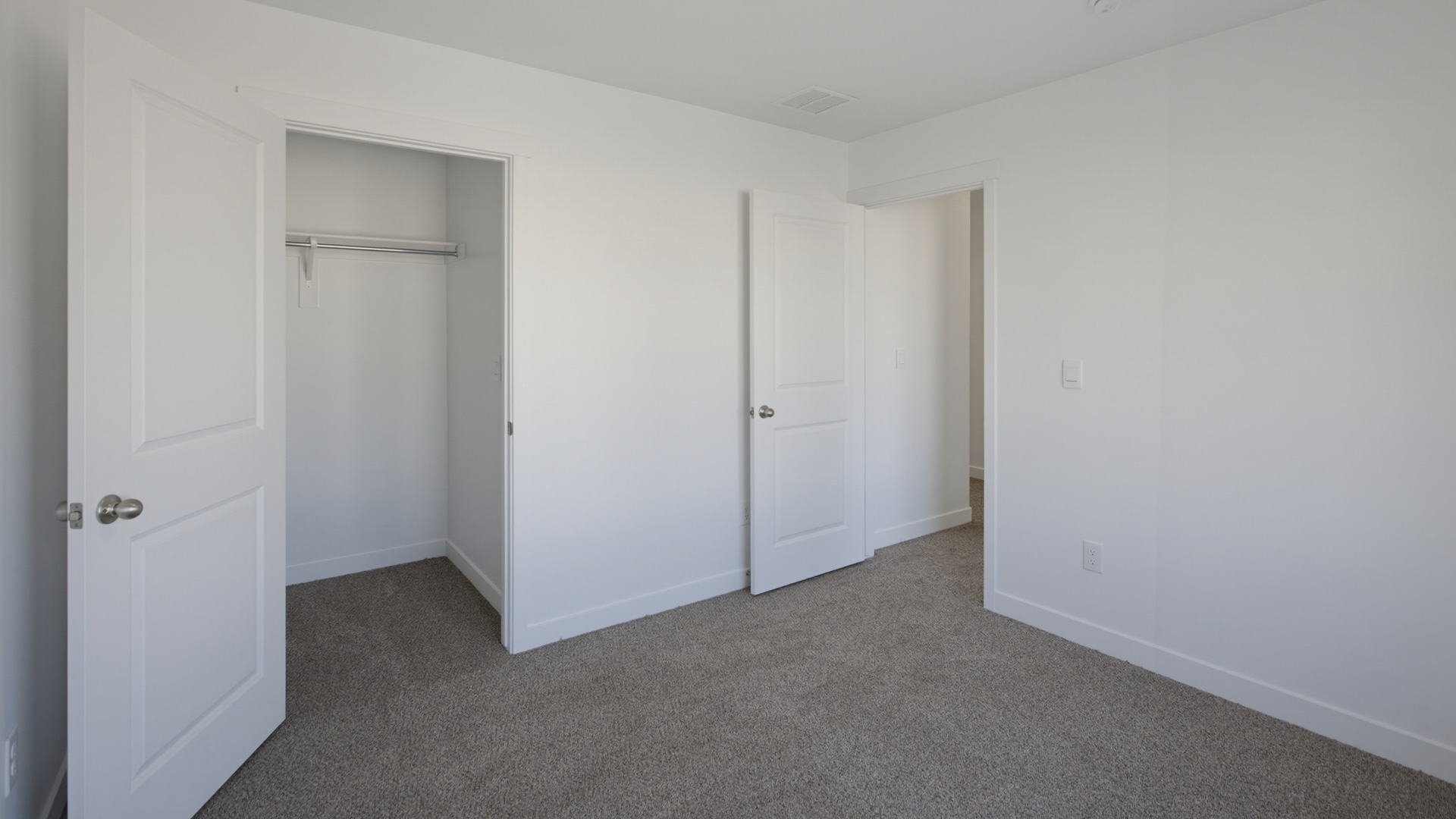 Laundry area behind double doors in hallway