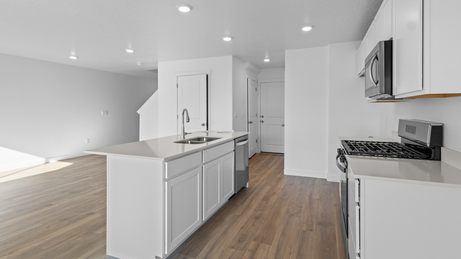 Kitchen with kitchen island and stainless steel appliances.