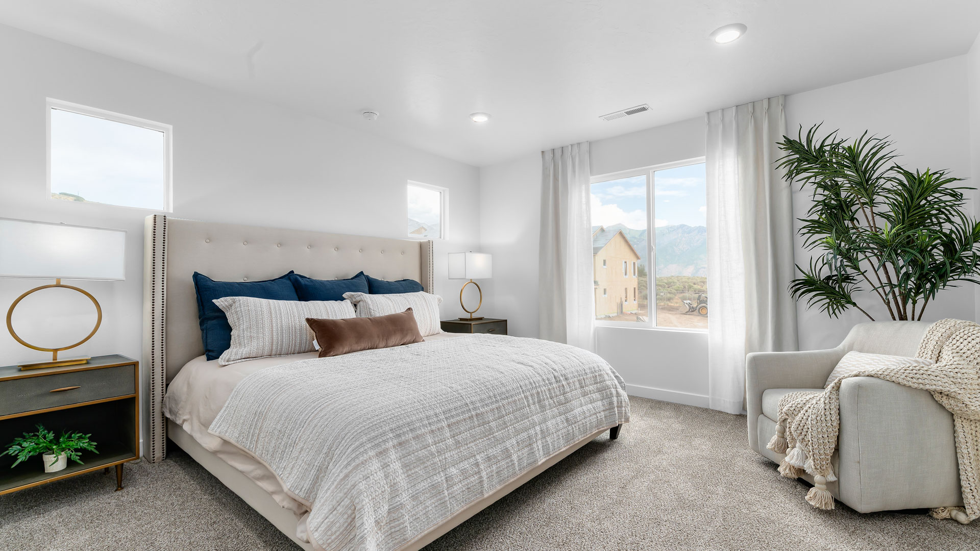 Primary bedroom with large windows.