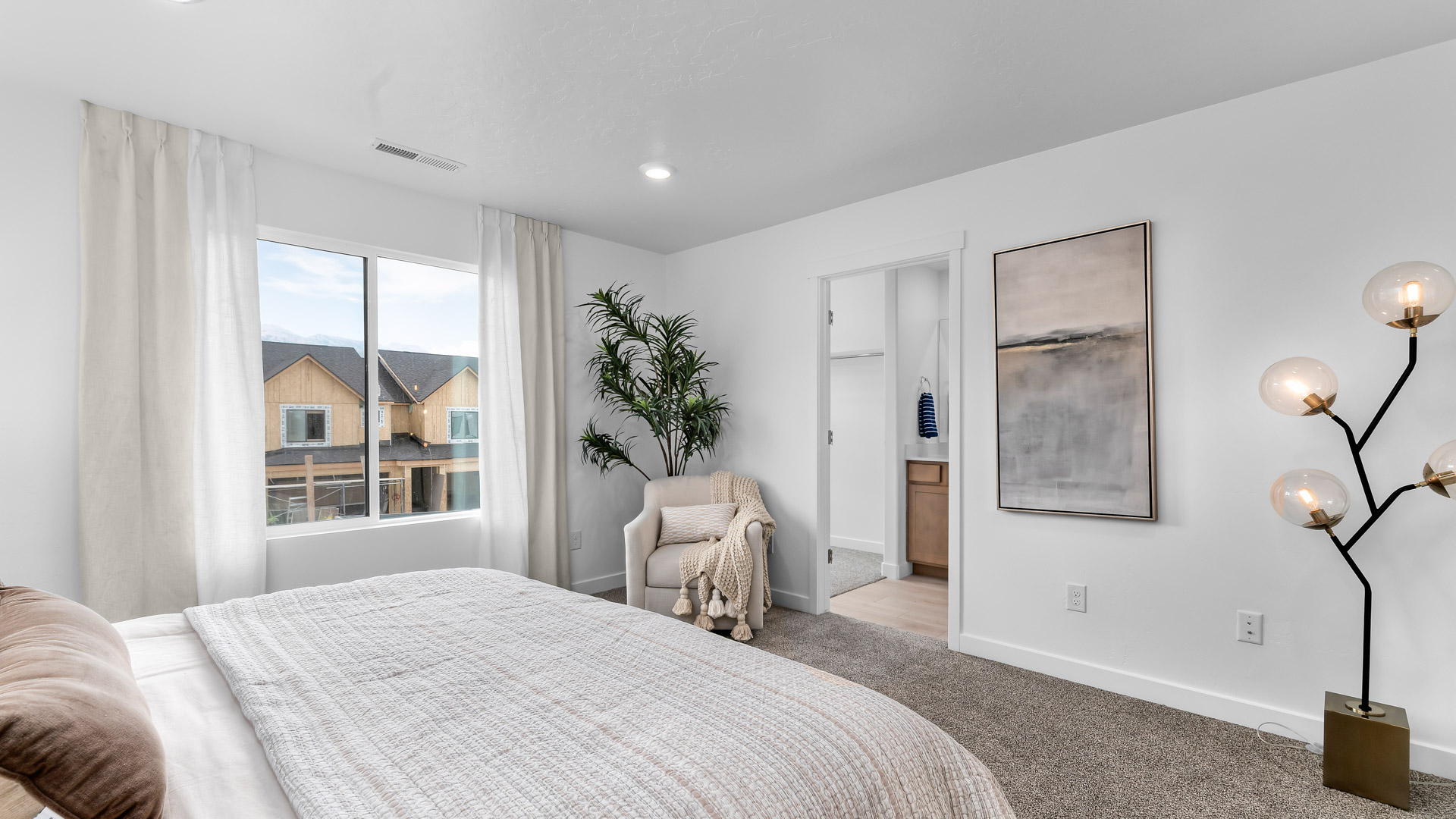 Primary bedroom with large windows.