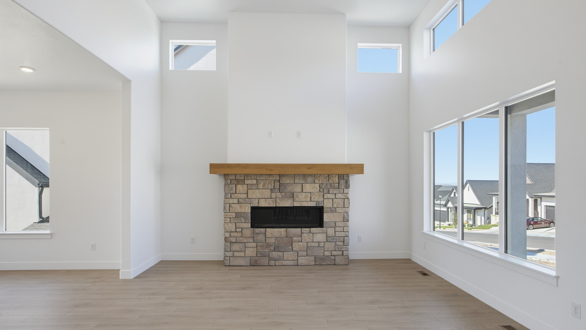 Family room with tall ceiling and fireplace.