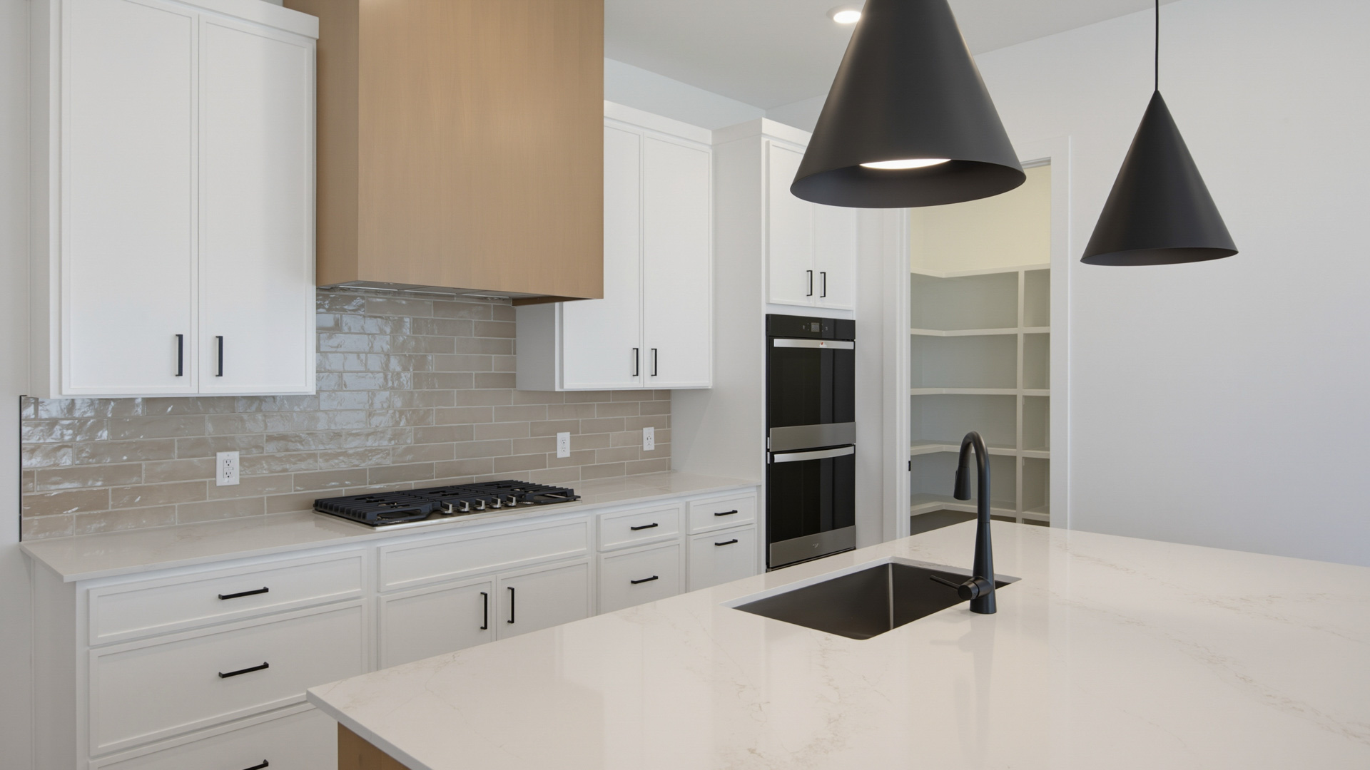 Kitchen with large kitchen island and stainless steel appliances.
