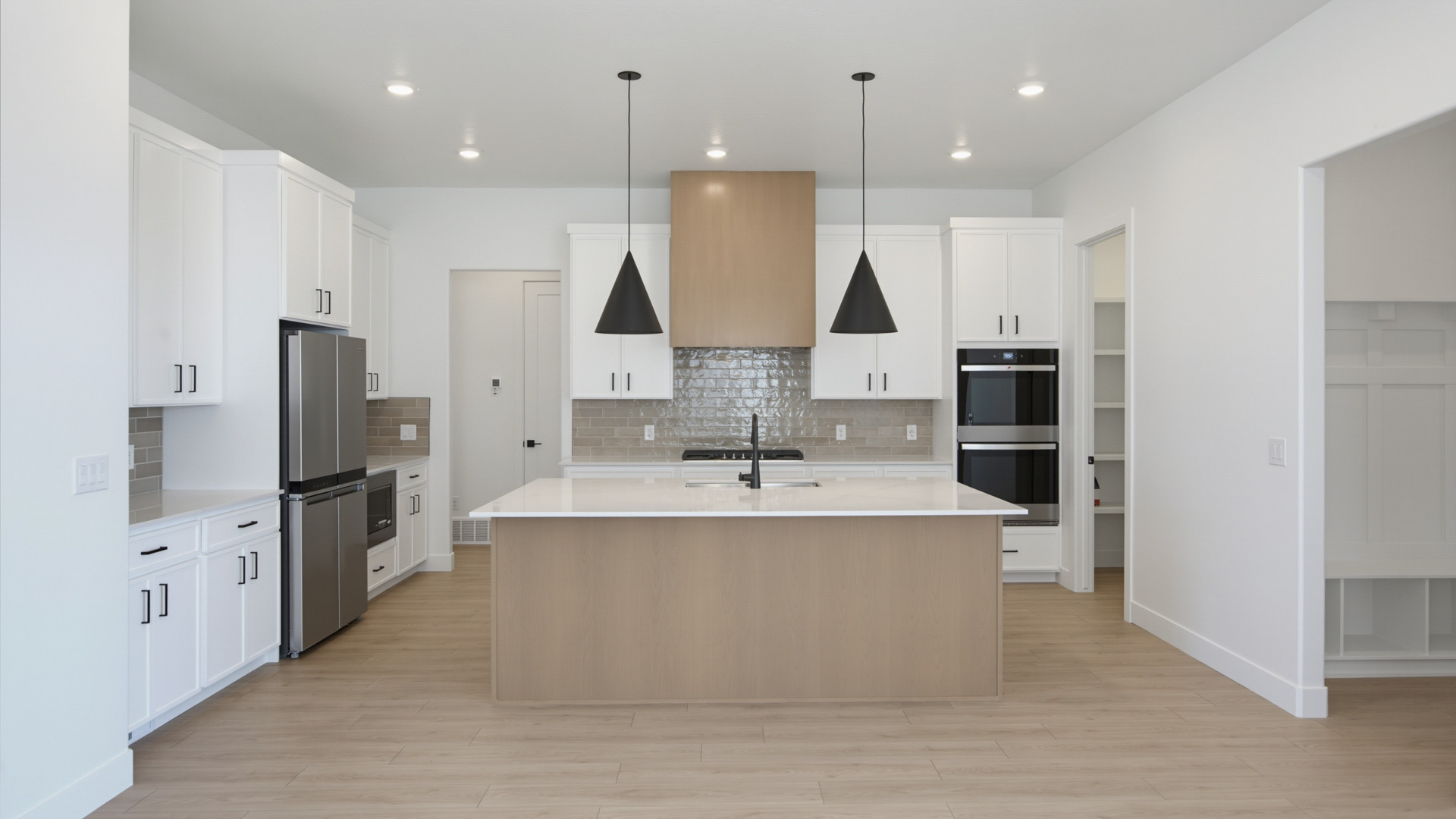 Kitchen with large kitchen island and stainless steel appliances.
