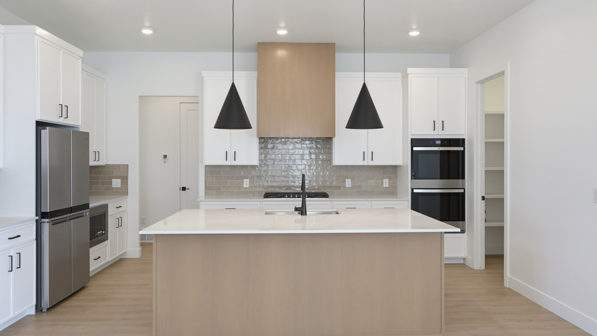Kitchen with large kitchen island and stainless steel appliances.