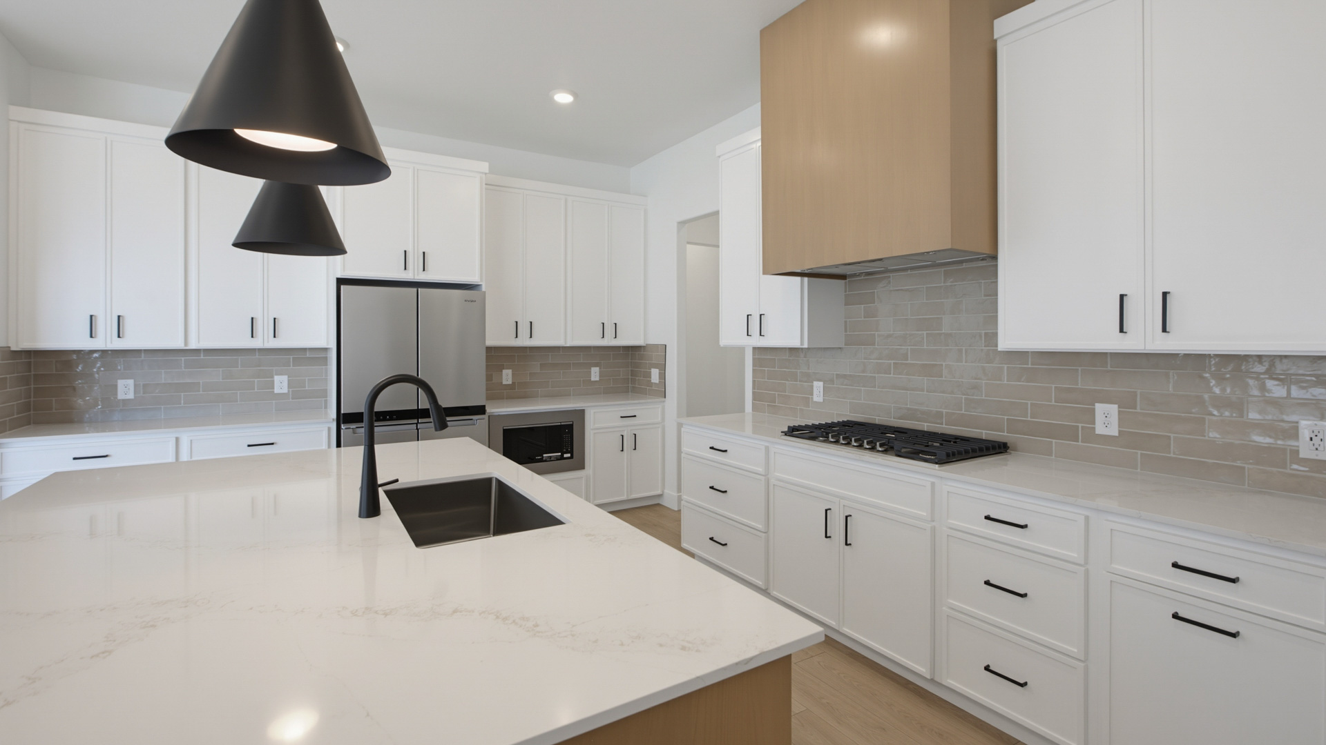 Kitchen with large kitchen island and stainless steel appliances.