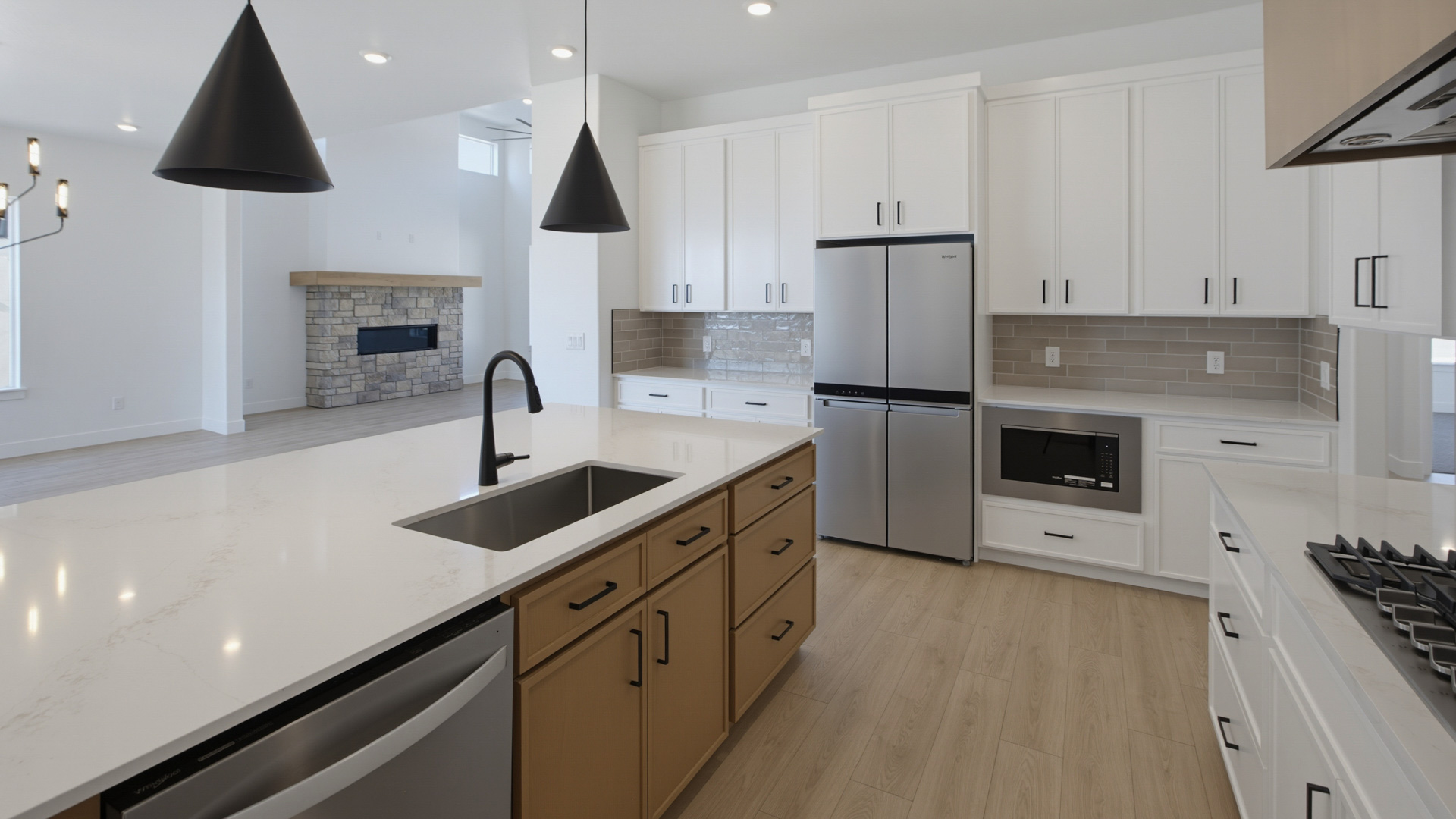 Kitchen with large kitchen island and stainless steel appliances.