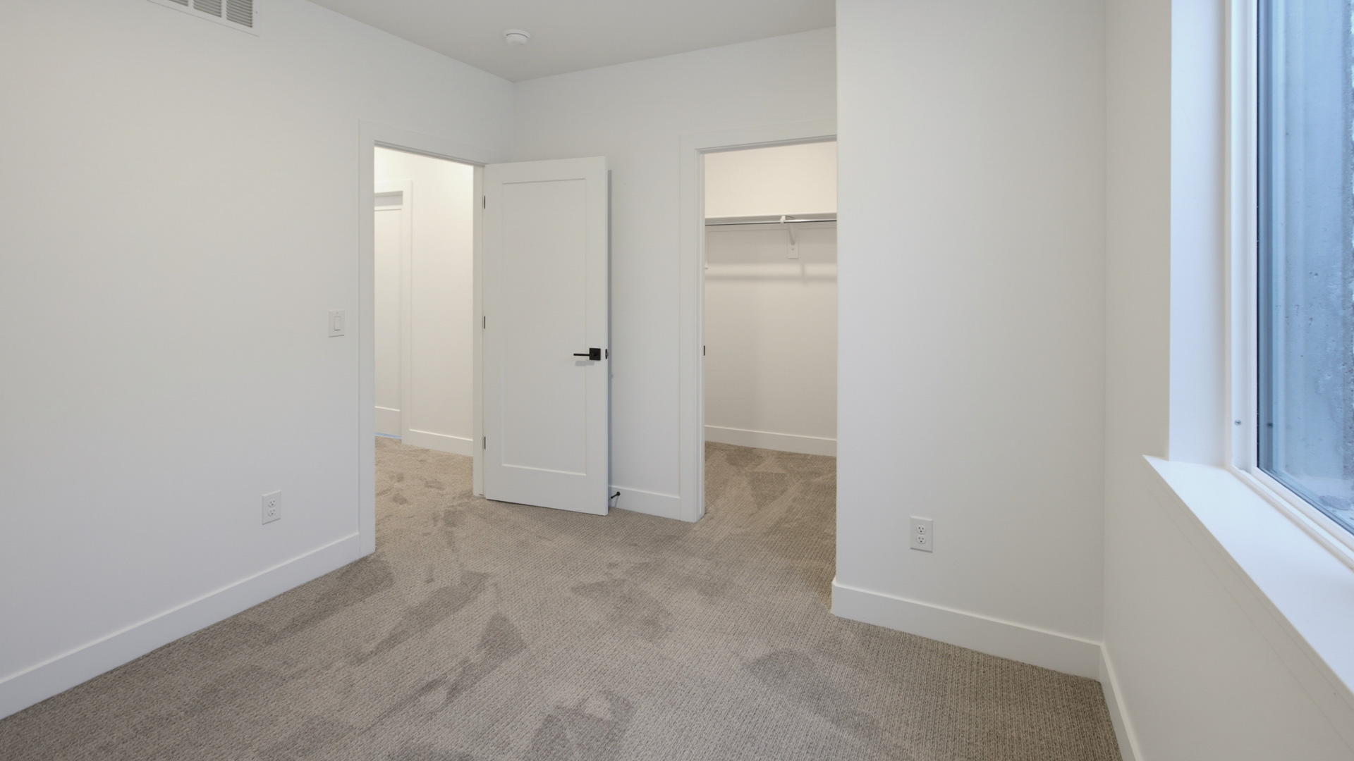 Basement bedroom with large window.