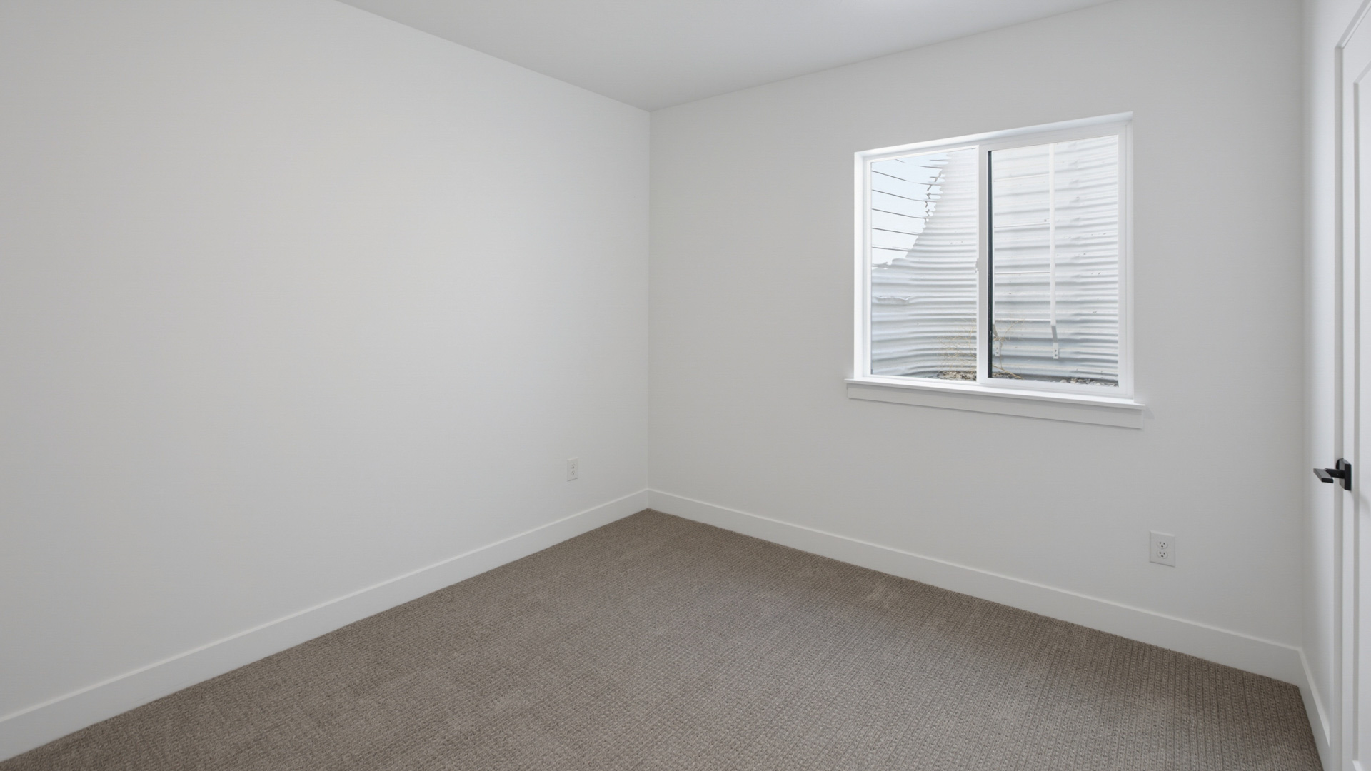 Basement bedroom with large window.