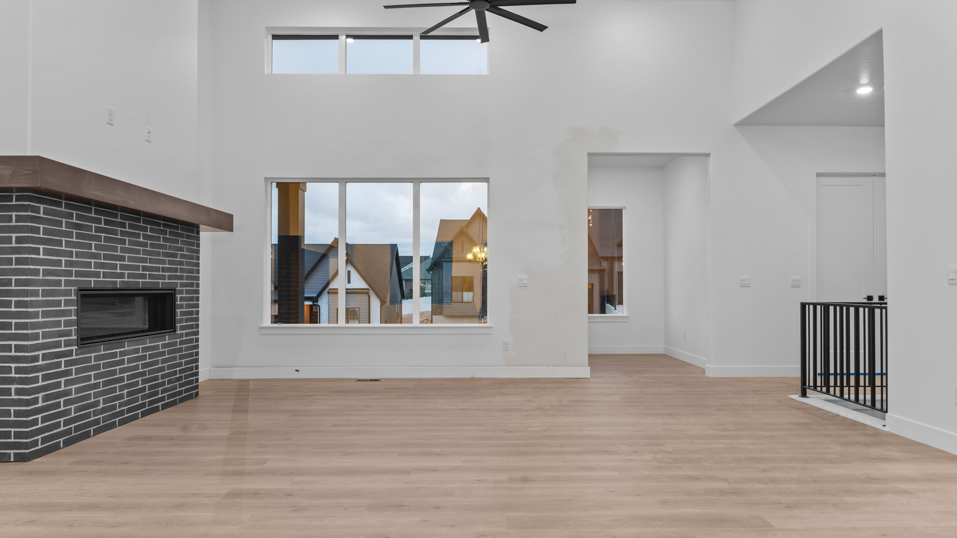Family room with tall ceiling and fireplace.