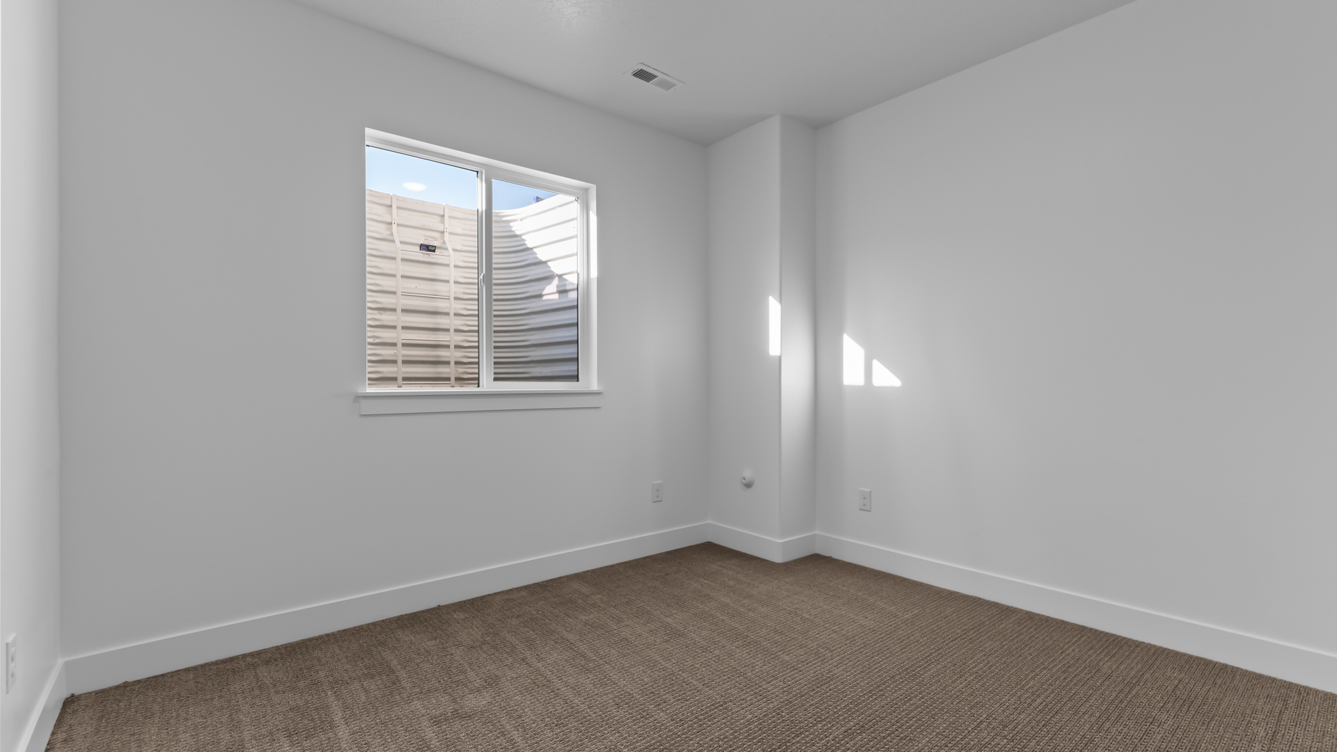 Basement bedroom with window.