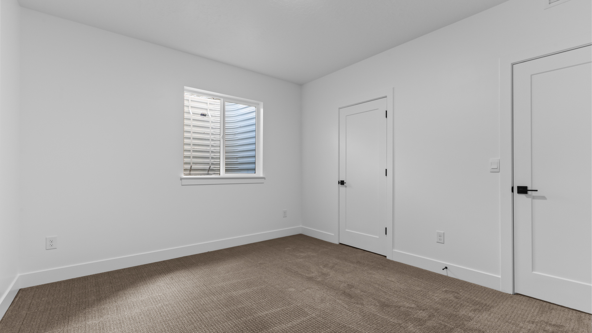 Basement bedroom with window.