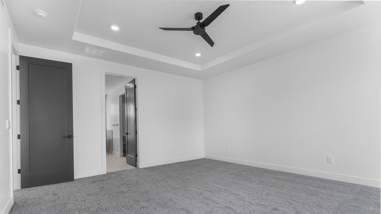 Primary bedroom with door out to deck.