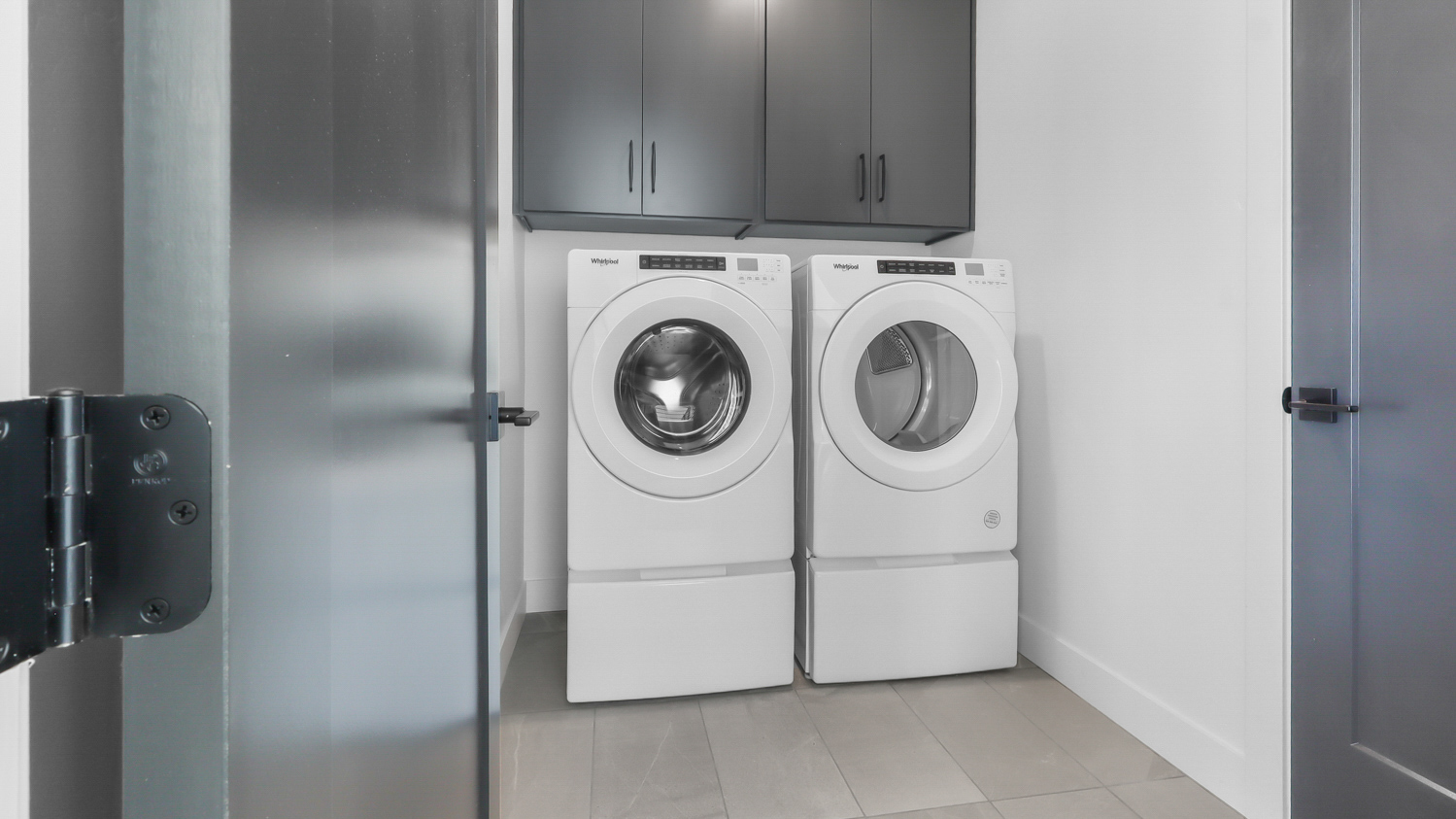 Laundry room with cabinets.