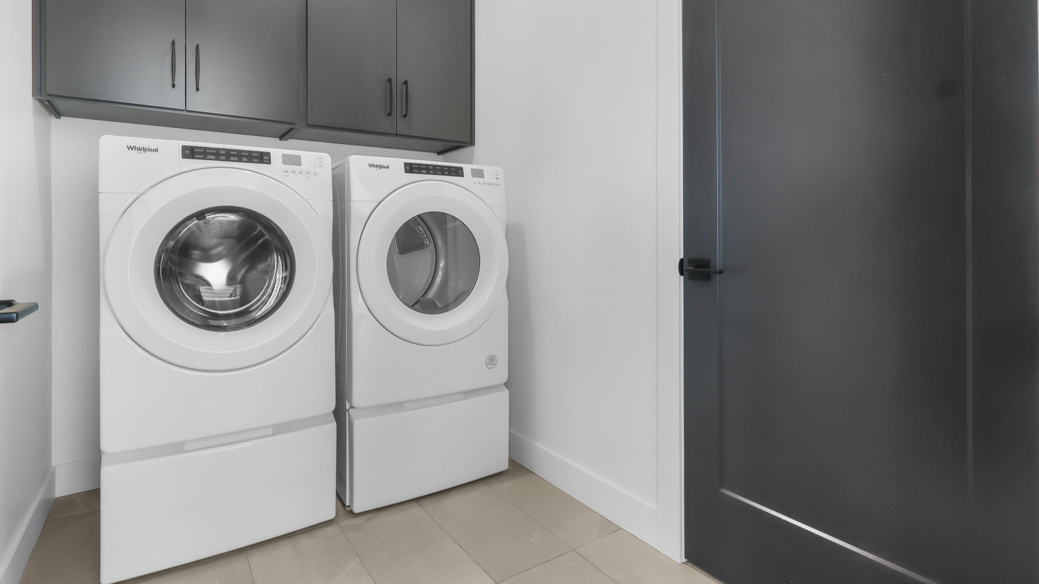 Laundry room with cabinets.