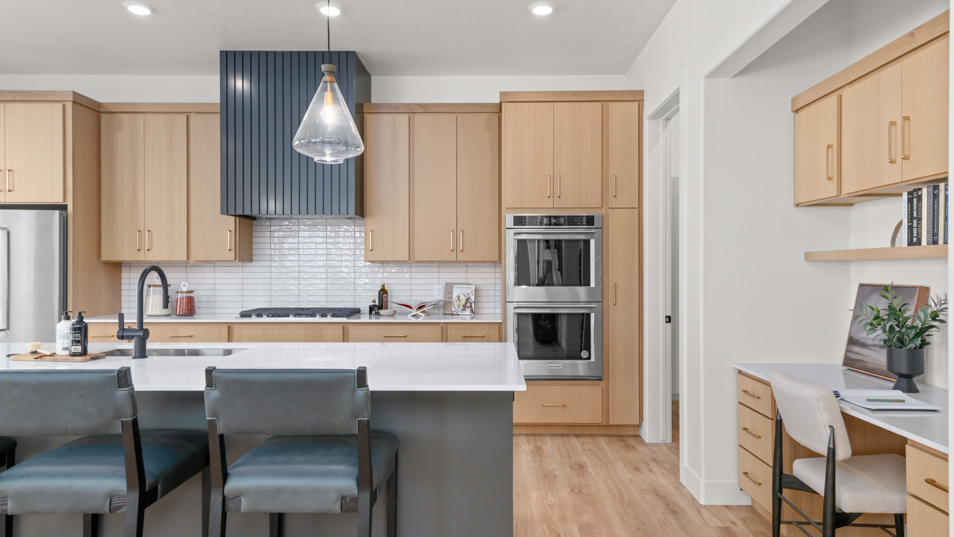 Kitchen with large kitchen island, cabinets, stainless steel appliances.
