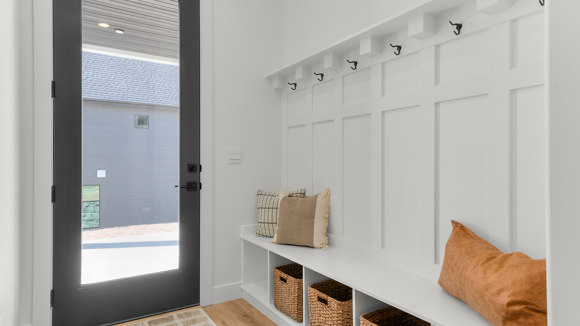 Mudroom with linen closet off of garage and covered patio.