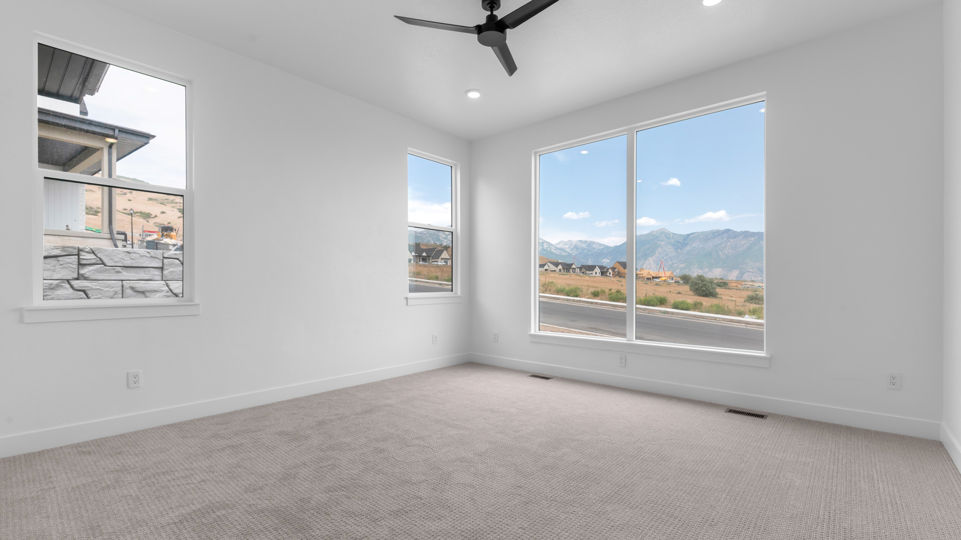Primary bedroom with large windows.