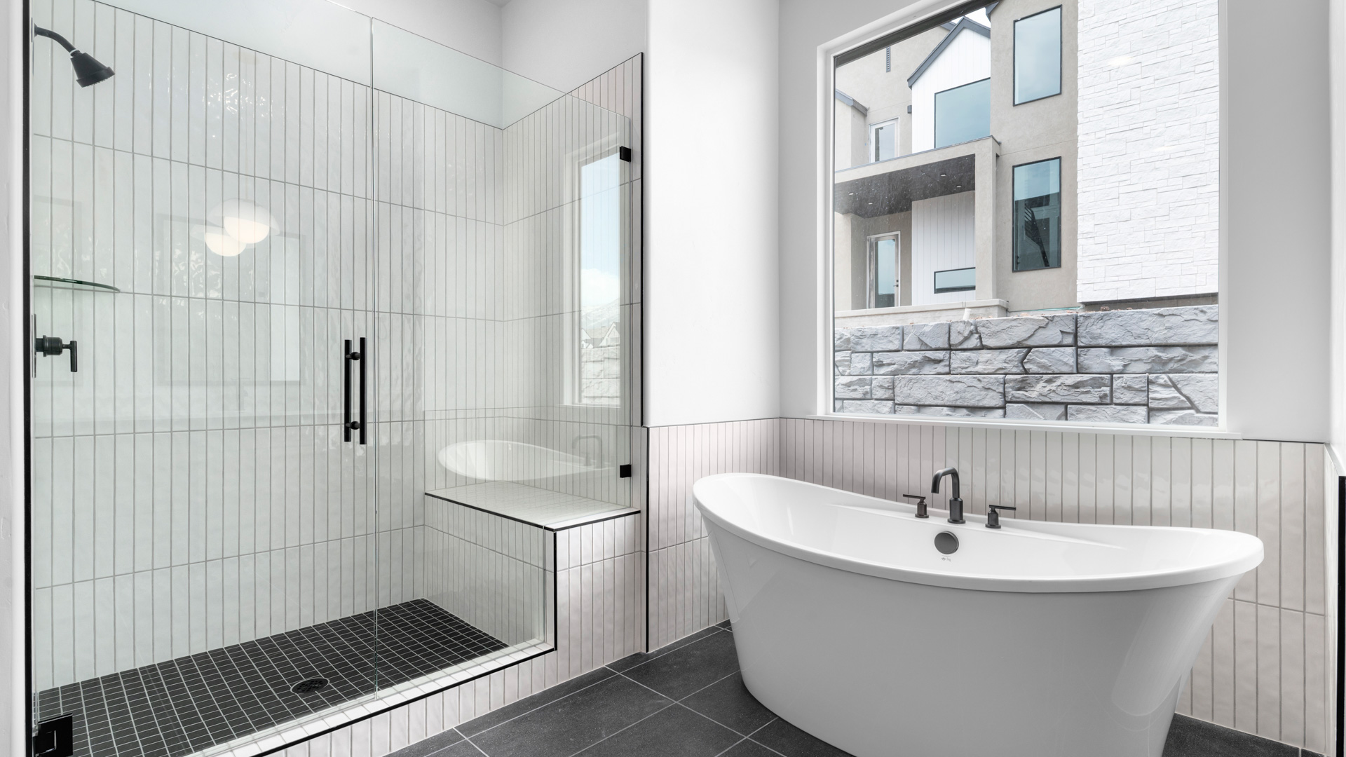 Primary bathroom with glass shower and tub.