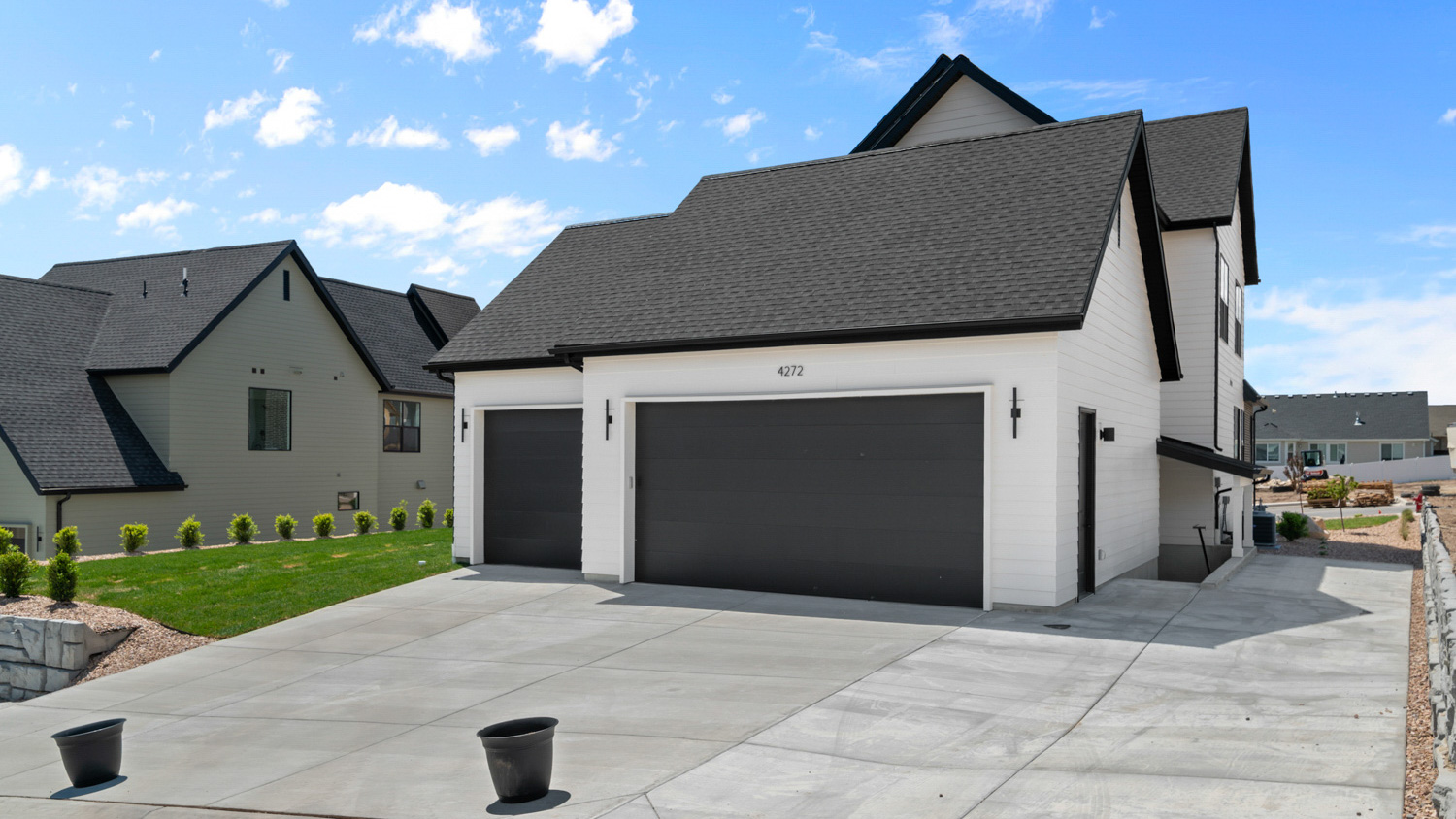 Back of home featuring garages.