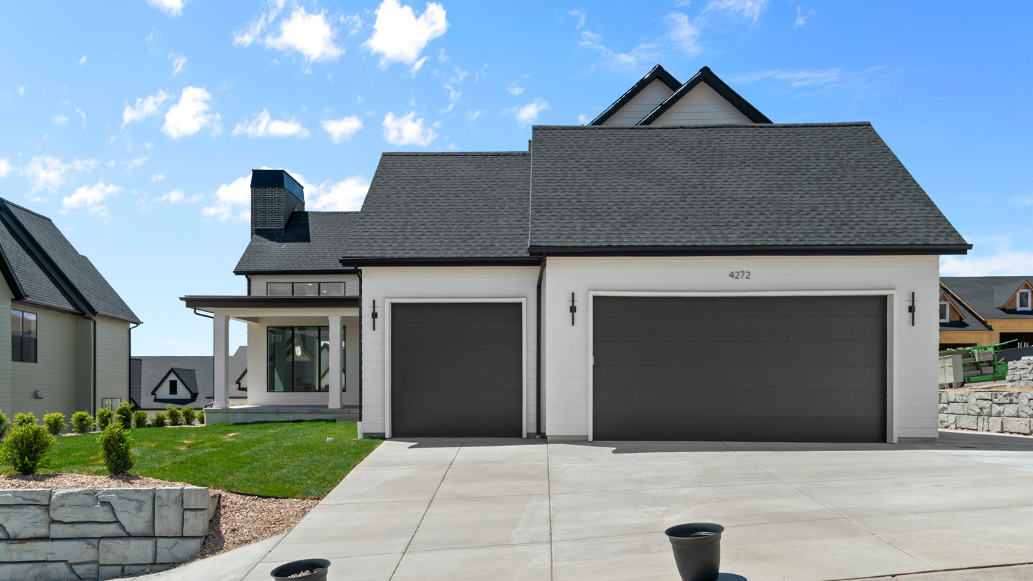 Back of home featuring garages.