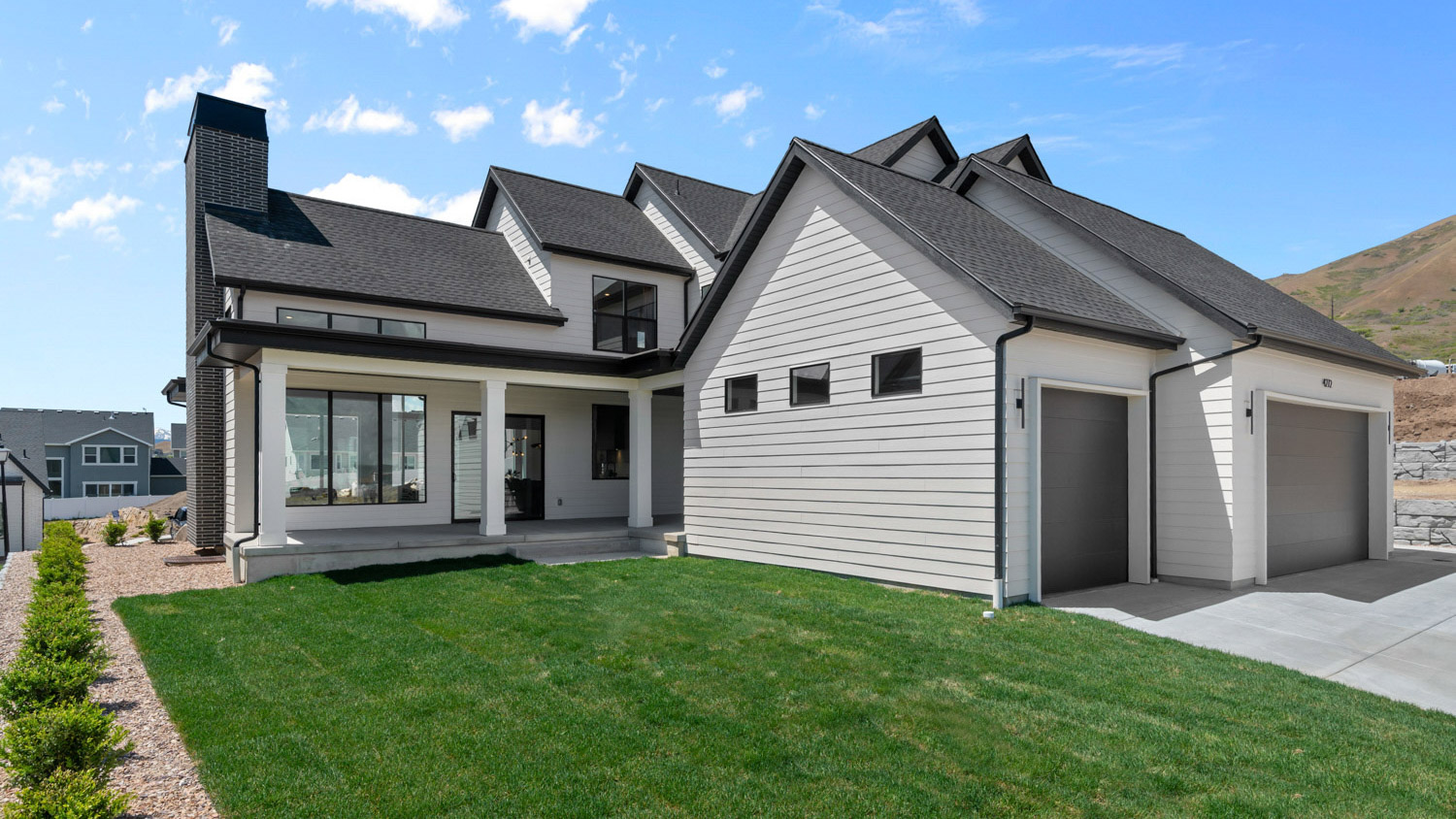 Back of home featuring garages.